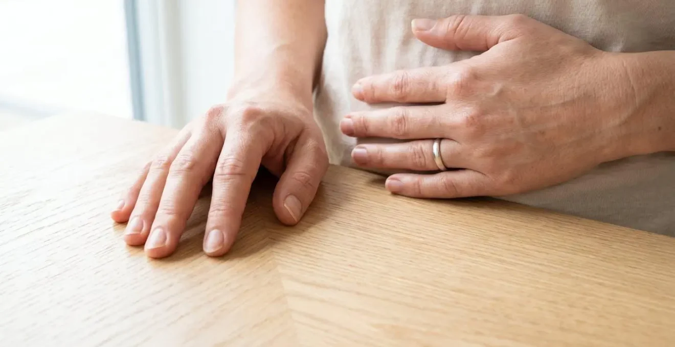 Gros plan sur des mains posées sur le diaphragme lors d'un exercice de respiration profonde